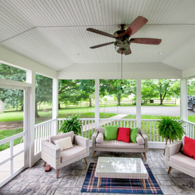 Home Additions - Golden Rule Builders - Home Remodel and Addition, screened in porch with beautiful stone flooring and a ceiling fan.