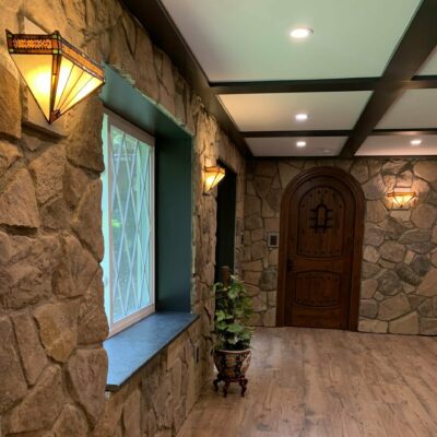 Lambert basement in Amissville, VA, spacious, rustic main room with beautiful stone walls, a great view, wood floors, and a wood front door, Golden Rule Builders